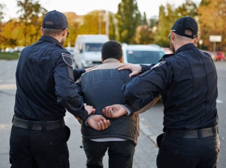 a group of police officers arrested a man