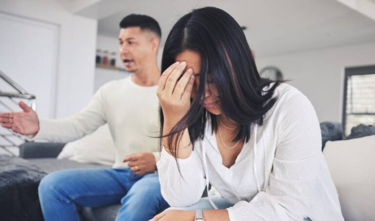 a woman holding her face with her hand couple discussion