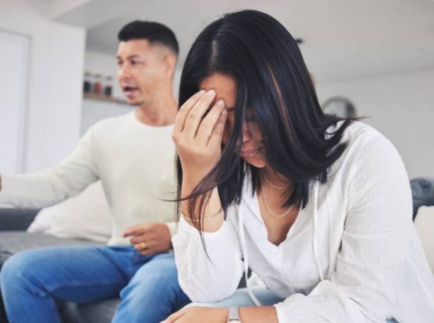 a woman holding her face with her hand couple discussion