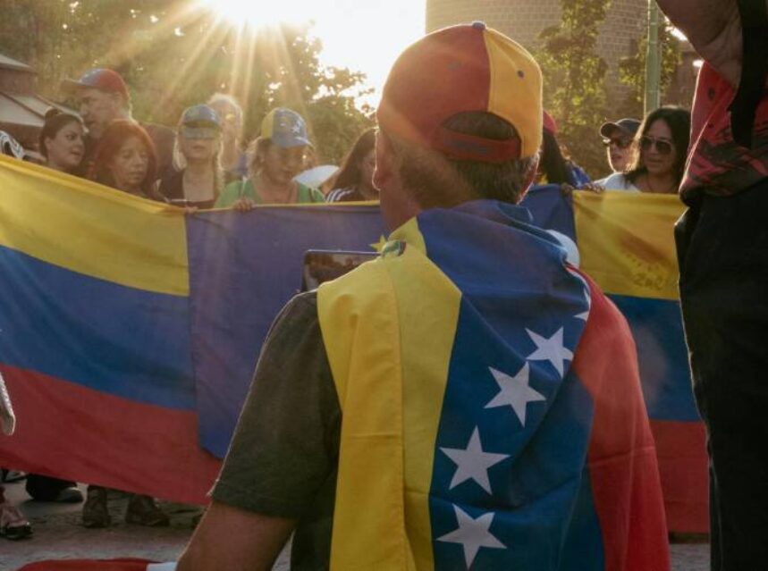 a group of people holding Venezuela flags