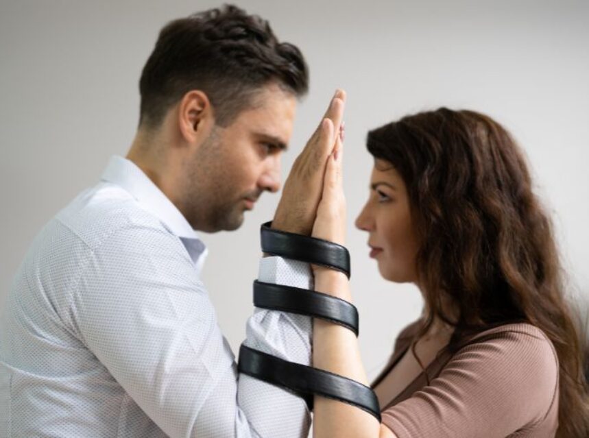 a man and woman holding hands together