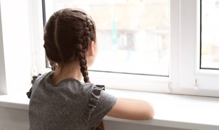 a girl looking out a window